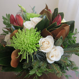 Flowers used:  cream roses, green chrysanthemums, red amaryllis, white lisianthus, magnolia leaves, evergreens boughs