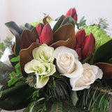 Flowers used:  cream roses, green chrysanthemums, red amaryllis, white lisianthus, magnolia leaves, evergreens boughs