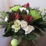 Flowers used:  cream roses, green chrysanthemums, red amaryllis, white lisianthus, magnolia leaves, evergreens boughs