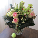 Flowers used:  pink roses, chartreuse cymbidium orchids , white amaryllis, white hypericum berries, evergreens boughs