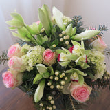 Flowers used:  pink roses, chartreuse cymbidium orchids , white amaryllis, white hypericum berries, evergreens boughs