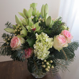 Flowers used:  pink roses, chartreuse cymbidium orchids , white amaryllis, white hypericum berries, evergreens boughs