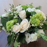 Flowers used: cream roses, white ranunculus and lisianthus green hydrangeas