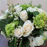 Flowers used: cream roses, white ranunculus and lisianthus green hydrangeas