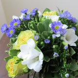 Flowers used: yellow/chartreuse roses, blue asters, white freesias