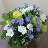 Flowers used: yellow/chartreuse roses, blue asters, white freesias