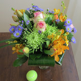 Flowers used: blush pink roses, orange orchids, red tulips, green chrysanthemums, blue aster daisies