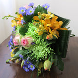 Flowers used: orange orchids, blush pink roses, green mums, red tulips and blue daisies