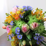 Flowers used: orange orchids, blush pink roses, green mums, red tulips and blue daisies