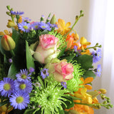 Flowers used: orange orchids, blush pink roses, green mums, red tulips and blue daisies