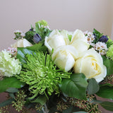 Flowers used: white roses, green chrysanthemums and viburnums blue/purple anemones, wax flowers, seeded eucalyptus