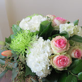Flowers used: pink blush roses, green chrysanthemums, red tulips, white hydrangeas, seeded eucalyptus