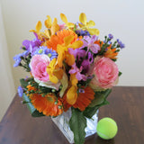 Flowers used: blush pink roses, orange gerberas, yellow, orange and mauve orchids, blue aster daisies