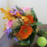 Flowers used: blush pink roses, yellow, orange and mauve orchids, orange gerberas, blue daisies