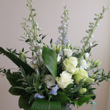 Flowers used: green roses, white lisianthus, blue delphiniums