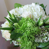 Flowers used: white roses, green chrysanthemums, white tulips, white wax flowers