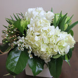 Flowers used: white roses, green chrysanthemums, white tulips, white wax flowers