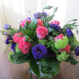 Flowers used: purple lisianthus, pink roses and, green viburnum