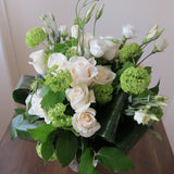 Flowers used: white roses, white lisianthus and green viburnum