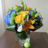 Flowers used: yellow roses, blue hydrangeas, yellow lilies and green viburnums