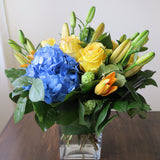 Flowers used: yellow roses, blue hydrangeas, yellow lilies and green viburnums