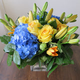 Flowers used: yellow roses, blue hydrangeas, yellow lilies and green viburnums