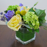 Flowers used: yellow roses, purple lisianthus, green hydrangeas