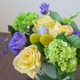 Flowers used: yellow roses, purple lisianthus, green hydrangeas