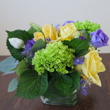 Flowers used: yellow roses, purple lisianthus, green hydrangeas