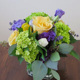 Flowers used: yellow roses, purple lisianthus, green hydrangeas