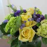 Flowers used: yellow roses, purple lisianthus, green hydrangeas, seeded eucalyptus