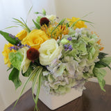 Flowers used: yellow roses, cream lisianthus, blue lavender, orange protea and rusty hydrangeas
