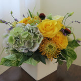 Flowers used: yellow roses, cream lisianthus, blue lavender, orange protea and rusty hydrangeas