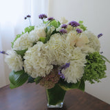 Flowers used: green and white hydrangeas, cream roses, white dahlias, blue verbena and lavender, pink sedums, hosta leaves