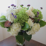 Flowers used: green and white hydrangeas, cream roses, white dahlias, blue verbena and lavender, pink sedums, hosta leaves