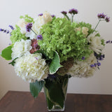 Flowers used: green and white hydrangeas, cream roses, white dahlias, blue verbena and lavender, pink sedums, hosta leaves