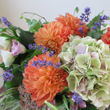 Flowers used: green hydrangeas, orange dahlias, white and pink lisianthus, pink turtleheads, green kales, pink sedums