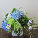 Flowers used: blue hydrangeas, purple/white lisianthus, white orchids, green chrysanthemums, hosta leaves and green kales
