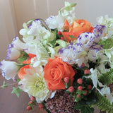 Flowers used: purple/white lisianthus, white orchids, orange roses, green chrysanthemums, pink hypericums and cream dahlias