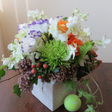 Flowers used: purple/white lisianthus, white orchids, orange roses, green chrysanthemums, pink hypericums and cream dahlias