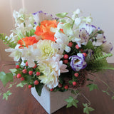 Flowers used: purple/white lisianthus, white orchids, orange roses, green chrysanthemums, pink hypericums and cream dahlias