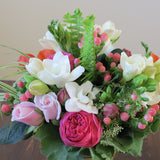 Flowers used: pink roses, orange ranunculus, white freesias, white Anne's Lace, pink hypericum berries