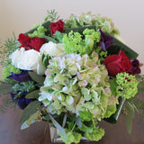 white and burgundy roses, green hydrangeas, purple anemone, blue lisianthus