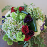 white and burgundy roses, green hydrangeas, purple anemone, blue lisianthus