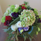 white and burgundy roses, green hydrangeas, purple anemone, blue lisianthus
