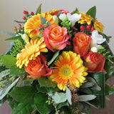 Flowers used: orange roses and gerberas, white freesias, red hypericum berries, green seeded eucalyptus