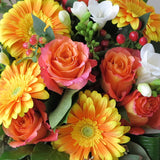 Flowers used: orange roses and gerberas, white freesias, red hypericum berries, green seeded eucalyptus