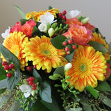 Flowers used: orange roses and gerberas, white freesias, red hypericum berries, green seeded eucalyptus