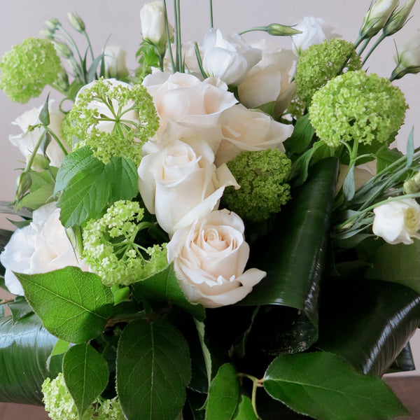 Flowers used: white roses, white lisianthus and green viburnum