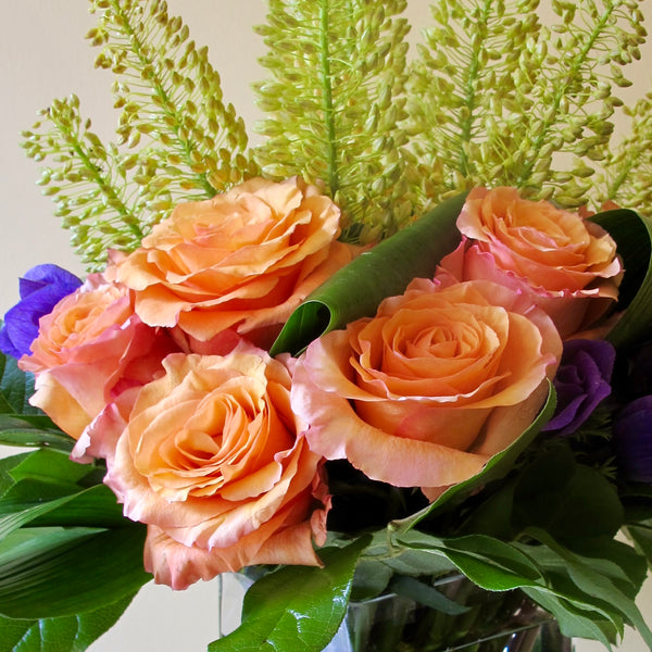 Flowers used: orange roses, yellow eremurus, purple lisianthus